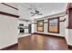 Spacious living area with newly finished wood floors, recessed lighting, and a view into the updated kitchen at 710 E Plymouth St, Tampa, FL 33603