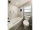 Beautiful bathroom with a new tiled shower, bathtub, and modern toilet at 710 Seminole, Clearwater, FL 33755