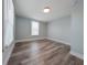 Bright bedroom featuring wood-look flooring, white trim, light blue walls, and new windows at 710 Seminole, Clearwater, FL 33755