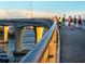 Pedestrians walking on a scenic bridge with views of the water and city skyline, enjoying an active lifestyle at 710 Seminole, Clearwater, FL 33755