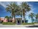 Exterior view of the building entrance, framed by four tall palm trees under a clear blue sky at 710 Seminole, Clearwater, FL 33755