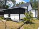 Exterior side view of home with screened porch and landscaped yard at 710 Seminole, Clearwater, FL 33755