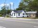 Street view of charming, two-story white home with black trim and dark roof situated next to a smaller tan building at 710 Seminole, Clearwater, FL 33755