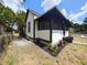 Exterior side view of home with screened porch and landscaped yard at 710 Seminole, Clearwater, FL 33755