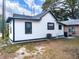 Exterior rear view of home with black trim and dark gray roof at 710 Seminole, Clearwater, FL 33755
