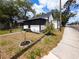 Charming front exterior view of home with screened porch and landscaped yard at 710 Seminole, Clearwater, FL 33755