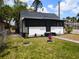 Charming house featuring a screened-in front porch and a well-maintained front lawn at 710 Seminole, Clearwater, FL 33755