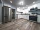 Renovated kitchen featuring stainless steel appliances, white cabinets, and modern finishes at 710 Seminole, Clearwater, FL 33755