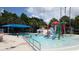 Resort-style swimming pool featuring a splash pad, mushroom waterfall and a covered canopy area at 710 Seminole, Clearwater, FL 33755