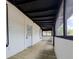 Long screened porch with freshly stained wood floors and white walls at 710 Seminole, Clearwater, FL 33755