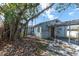 View of a home's exterior from the backyard, including a covered carport at 7105 Blind Pass Rd, St Pete Beach, FL 33706