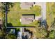 This aerial view showcases a property with a well-maintained lawn surrounded by a privacy fence at 818 S Main St, Brooksville, FL 34601