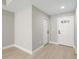 Clean, freshly painted foyer with a bright white front door and durable wood-look flooring at 818 S Main St, Brooksville, FL 34601