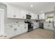 Modern kitchen features white cabinetry, stainless steel appliances, and light countertops at 818 S Main St, Brooksville, FL 34601