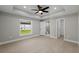 Spacious main bedroom features light-colored walls, modern ceiling fan, and ensuite bathroom access at 818 S Main St, Brooksville, FL 34601