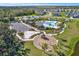 An aerial view of the community amenities, featuring a pool, clubhouse, playground, parking, and beautiful landscaping at 8337 Abalone Loop, Parrish, FL 34219