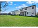 Spacious backyard with lush green lawn and view of other homes in the neighborhood at 8337 Abalone Loop, Parrish, FL 34219