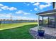 Lush backyard with a patio, landscaping, and a serene lake view at 8337 Abalone Loop, Parrish, FL 34219