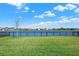 Expansive backyard with lush green lawn and serene lake views at 8337 Abalone Loop, Parrish, FL 34219