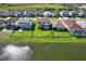 An aerial view of homes with fenced backyards overlooking a serene lake, highlighting privacy and waterfront living at 8337 Abalone Loop, Parrish, FL 34219