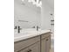 Bathroom featuring double vanity, modern fixtures, and large mirror with decorative lighting above at 8337 Abalone Loop, Parrish, FL 34219