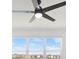Bedroom features a ceiling fan and a window with a neighborhood view at 8337 Abalone Loop, Parrish, FL 34219
