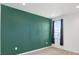 Bedroom showcases a vibrant green accent wall, plush carpet, and a window with natural light at 8337 Abalone Loop, Parrish, FL 34219