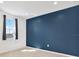 Bedroom features a dark blue accent wall and a window providing natural light and neighborhood view at 8337 Abalone Loop, Parrish, FL 34219