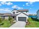 Charming two-story home boasts a modern farmhouse aesthetic with a well-manicured lawn at 8337 Abalone Loop, Parrish, FL 34219