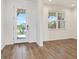 Bright foyer features wood flooring, a glass front door and a view of the manicured front yard at 8337 Abalone Loop, Parrish, FL 34219