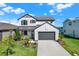 Charming two-story home with a modern farmhouse design and well-manicured landscaping at 8337 Abalone Loop, Parrish, FL 34219