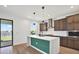 Bright kitchen features a large island with a stylish backsplash, modern appliances, and ample cabinet space at 8337 Abalone Loop, Parrish, FL 34219