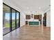 Open-concept kitchen features a large island, stainless steel appliances, and is adjacent to a spacious open floorplan at 8337 Abalone Loop, Parrish, FL 34219
