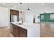 Bright kitchen with a large island and seating, stylish cabinets and stainless steel appliances with views to the living area at 8337 Abalone Loop, Parrish, FL 34219