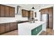 Modern kitchen boasts ample counter space on the large island, stylish lighting and stainless steel appliances at 8337 Abalone Loop, Parrish, FL 34219