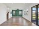 Expansive living room with a sliding glass door leading to the outdoor area, and a staircase to the second floor at 8337 Abalone Loop, Parrish, FL 34219