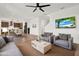 Inviting living room with comfortable seating and an open-concept layout flowing into the kitchen and dining area at 8337 Abalone Loop, Parrish, FL 34219
