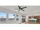 Spacious living area with beautiful lake views, large windows, and natural light that extends into an open kitchen at 8337 Abalone Loop, Parrish, FL 34219