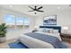 Bedroom with ceiling fan, mountain painting, lake view, and bedside tables at 8337 Abalone Loop, Parrish, FL 34219