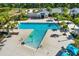 Aerial view of a community pool area with palm trees, lounge chairs, and a playground in a Gathering-friendly neighborhood at 8337 Abalone Loop, Parrish, FL 34219