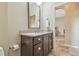 Bathroom vanity with dark wood cabinets and a light countertop at 9117 Brindlewood Dr, Odessa, FL 33556