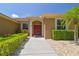 Inviting front entrance featuring double doors, a well-maintained walkway, and lush tropical landscaping at 9117 Brindlewood Dr, Odessa, FL 33556