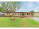 Charming brick single-story home with a well-manicured lawn and mature landscaping at 9611 Pine Ridge Ave, Riverview, FL 33578