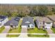 Aerial view of several homes in a neighborhood backing up to a wooded area at 9802 Carabiner Way, Land O Lakes, FL 34637