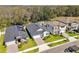An aerial shot showcases a neighborhood with well-manicured lawns and mature trees at 9802 Carabiner Way, Land O Lakes, FL 34637