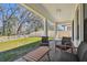 Covered patio with views of the lawn and privacy fence in the backyard at 9802 Carabiner Way, Land O Lakes, FL 34637