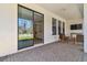 Covered back porch with patio furniture and sliding glass doors to the interior at 9802 Carabiner Way, Land O Lakes, FL 34637