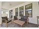 Covered back porch with outdoor furniture and a view of the backyard and privacy fence at 9802 Carabiner Way, Land O Lakes, FL 34637