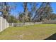 Picture of a lush, fully fenced backyard with mature trees providing shade at 9802 Carabiner Way, Land O Lakes, FL 34637