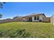 Image showing the rear of a home featuring a spacious backyard with green grass and a privacy fence at 9802 Carabiner Way, Land O Lakes, FL 34637